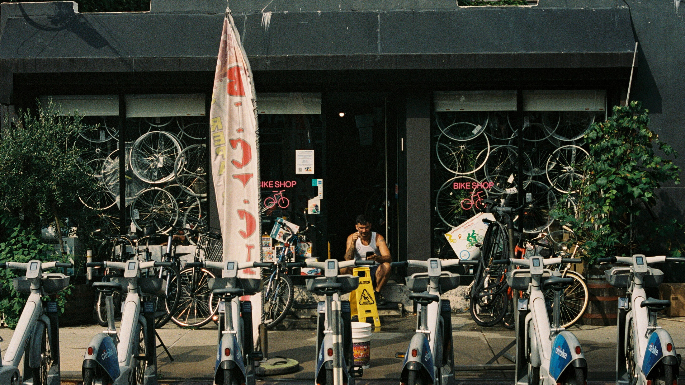 A bike shop selling wheels behind a Citi Bike dock in Red Hook, Brooklyn